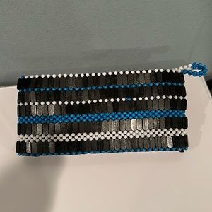 Clutch handbag, Color- Black with a blue and white trim. Hand woven and beaded.
